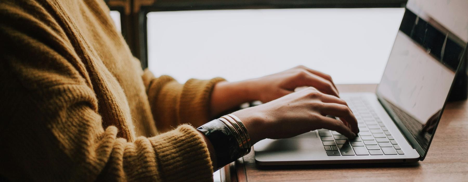 a person typing on a laptop