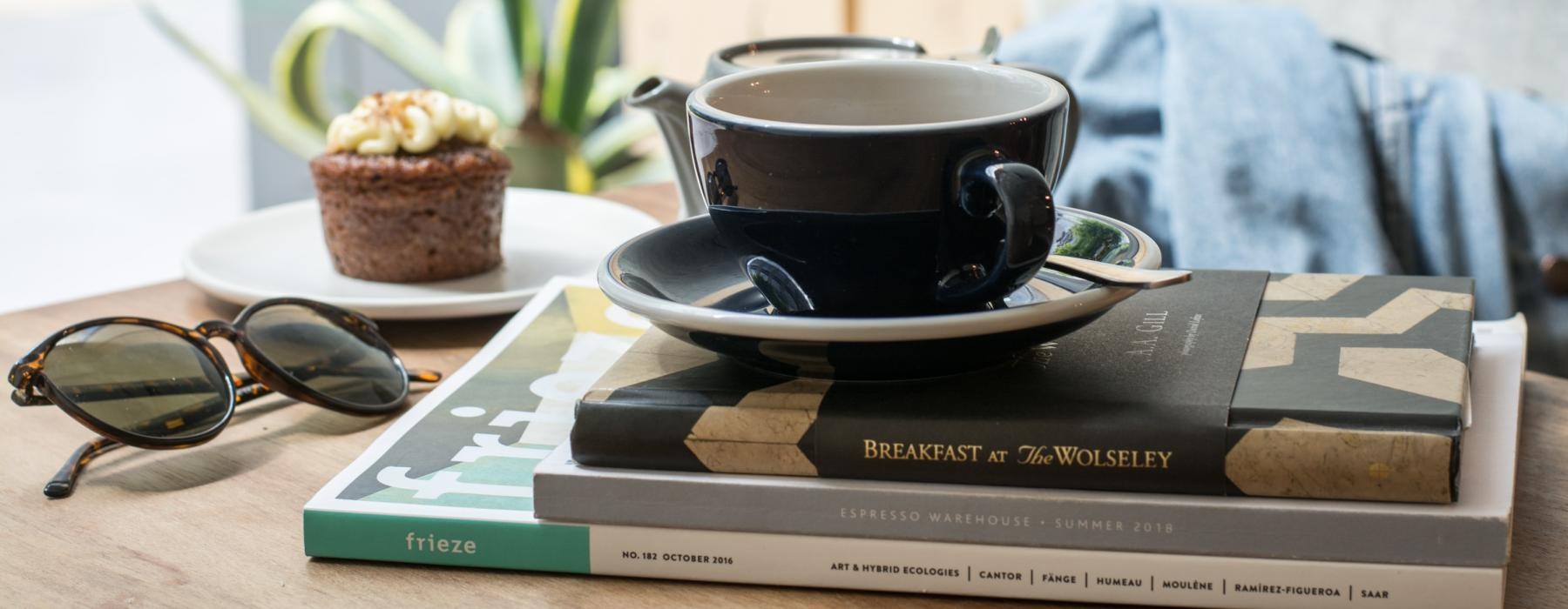 a cup of coffee and a book on a table