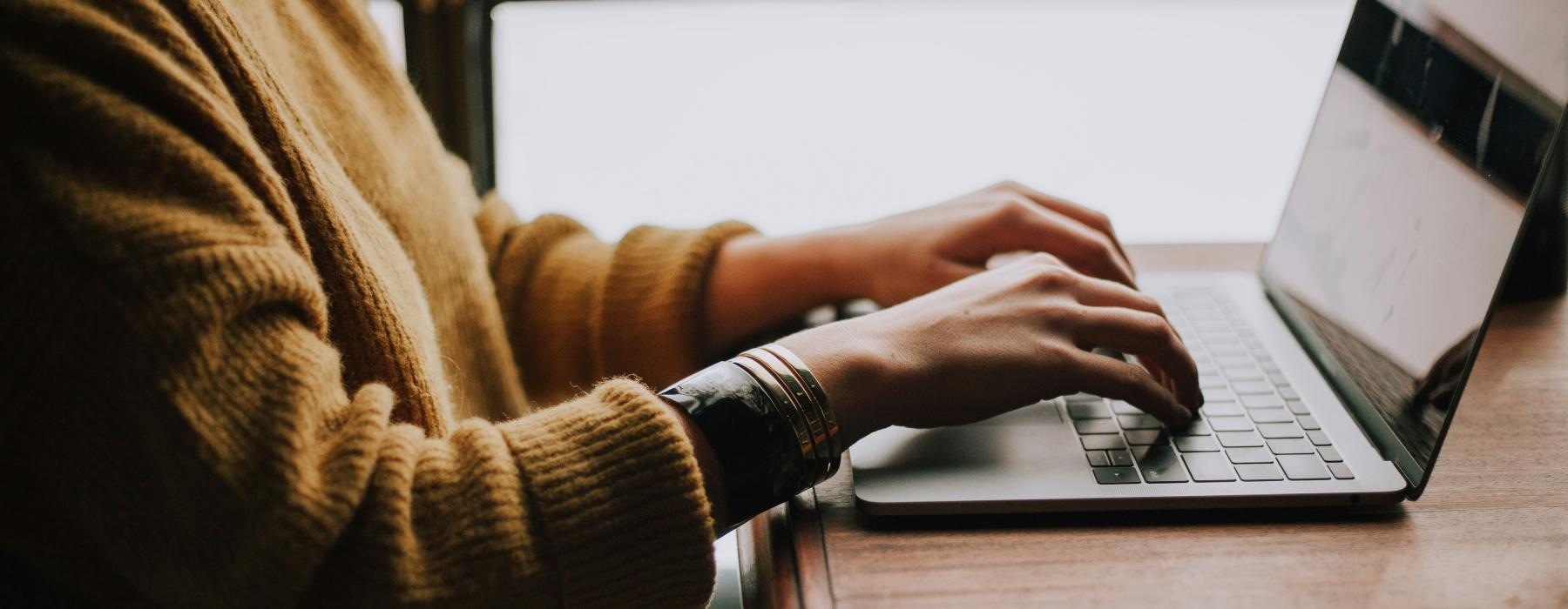 a person typing on a laptop