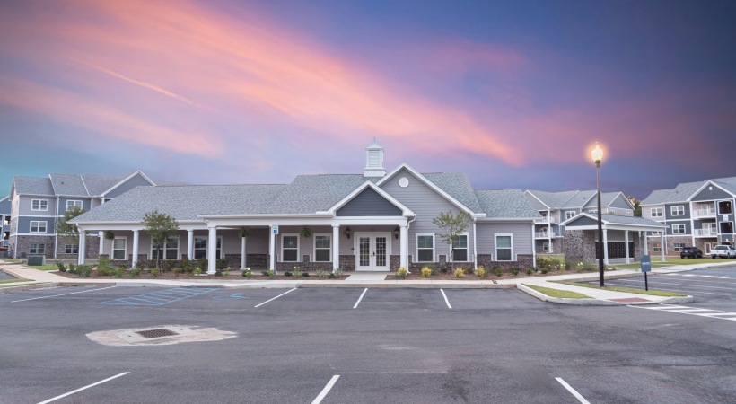 exterior of building with a spacious parking lot