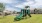 playground with swings and on green turf