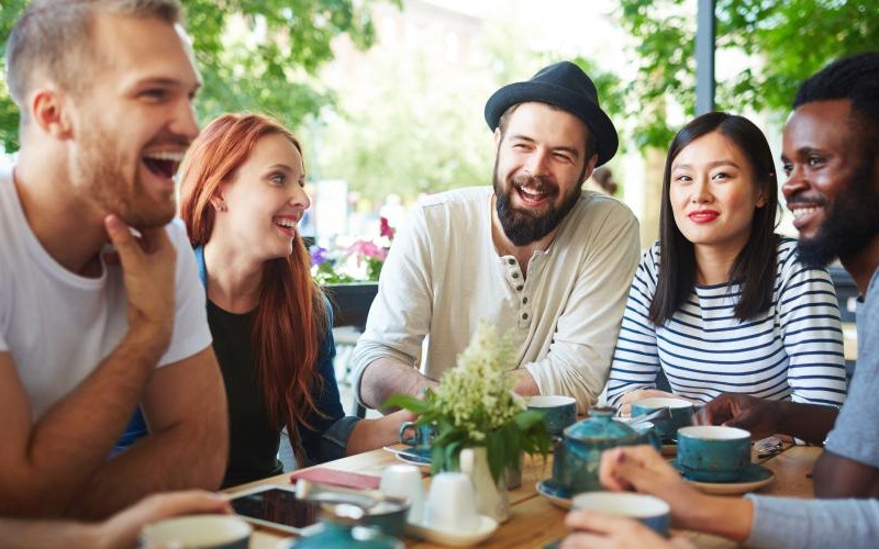 Lifestyle photo of a group of people sitting around a table